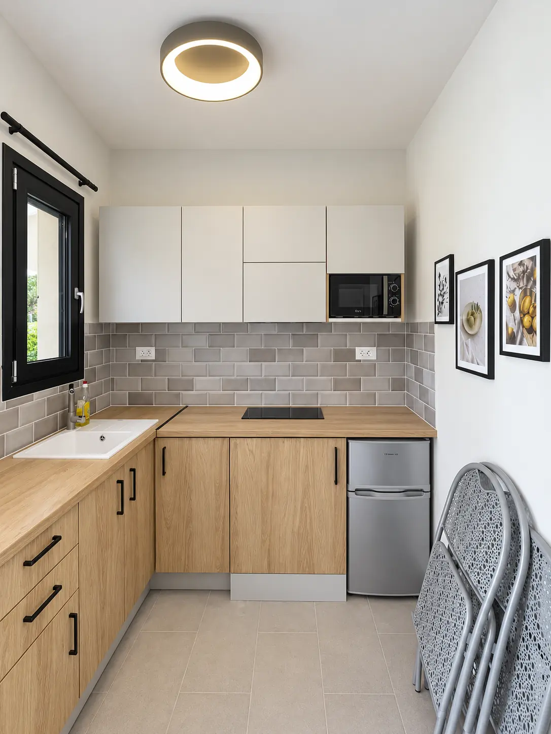 Compact custom kitchen with wood-effect lower cabinets and white upper cabinets